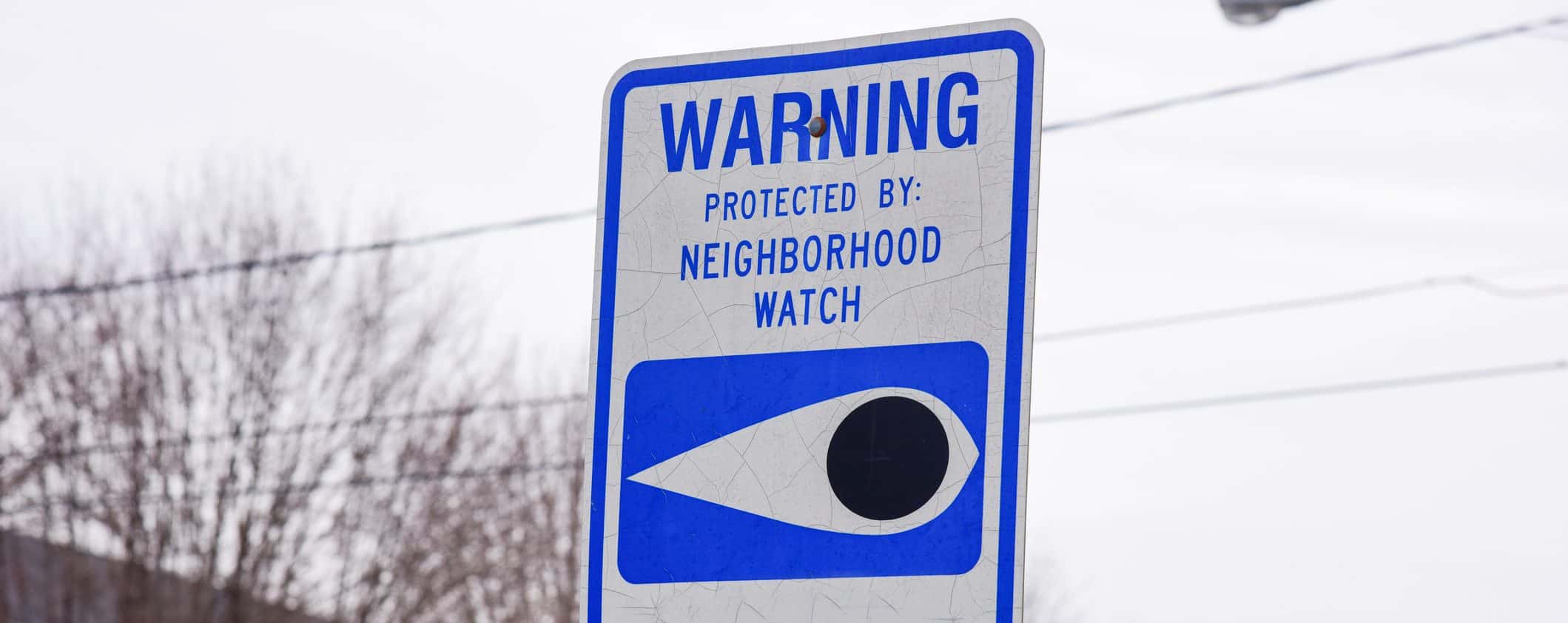 Blue and white neighborhood watch sign